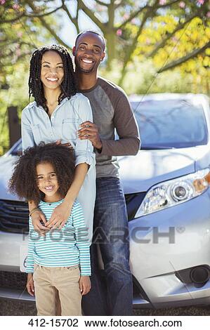 Portrait of happy family outside car View Large Photo Image Stock Image - Portrait of happy family outside car. Fotosearch