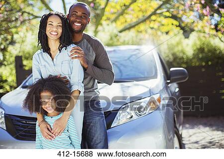 Portrait of happy family outside car View Large Photo Image Stock Photo - Portrait of happy family outside car. Fotosearch