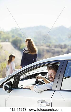 Portrait of happy man inside of car View Large Photo Image Stock Photo - Portrait of happy man inside of car. Fotosearch