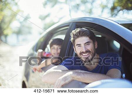 Portrait of smiling father and son leaning out car windows View Large Photo Image Stock Image - Portrait of smiling father and son leaning out car windows. Fotosearch