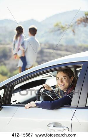 Portrait of smiling woman inside of car View Large Photo Image Stock Photo - Portrait of smiling woman inside of car. Fotosearch