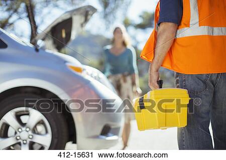 Roadside mechanic with toolbox arriving to help woman View Large Photo Image Stock Image - Roadside mechanic with toolbox arriving to help woman. Fotosearch
