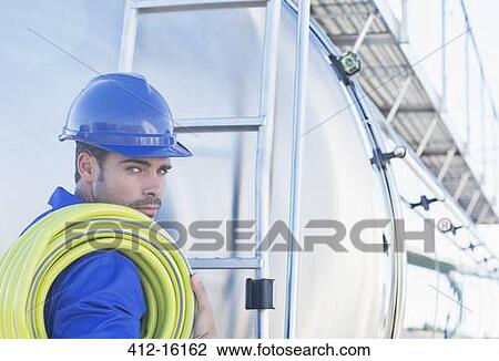 Portrait of serious worker with hose at back of stainless steel milk tanker View Large Photo Image Stock Image - Portrait of serious worker with hose at back of stainless steel milk tanker. Fotosearch
