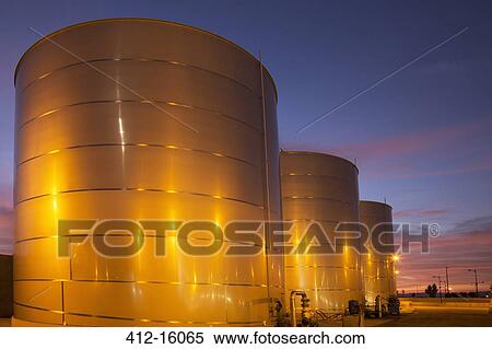 Silage storage tanks illuminated at night View Large Photo Image Stock Photography - Silage storage tanks illuminated at night. Fotosearch