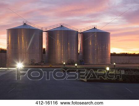 Stock Photograph - Silage storage towers against dramatic sky. Fotosearch