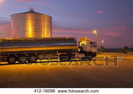 Stainless steel milk tanker parked next to silage storage tower at night View Large Photo Image Stock Photograph - Stainless steel milk tanker parked next to silage storage tower at night. Fotosearch