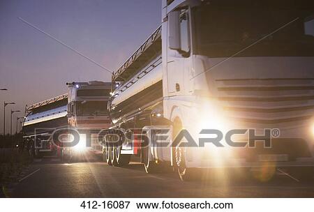 Stainless steel milk tankers in queue at night View Large Photo Image Stock Photo - Stainless steel milk tankers in queue at night. Fotosearch