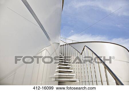 Stairs winding along stainless steel silage storage tower View Large Photo Image Stock Photo - Stairs winding along stainless steel silage storage tower. Fotosearch