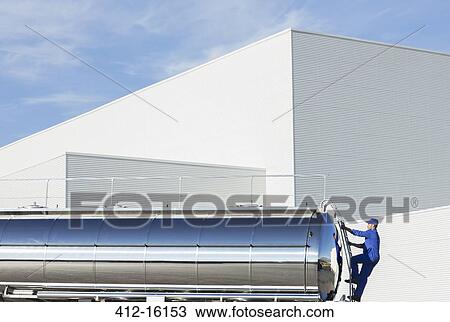 Worker climbing ladder at back of stainless steel milk tanker View Large Photo Image Stock Image - Worker climbing ladder at back of stainless steel milk tanker. Fotosearch