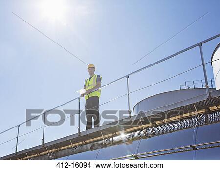 Worker on platform above milk tanker View Large Photo Image Picture - Worker on platform above milk tanker. Fotosearch