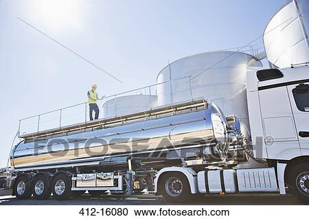 Worker on platform above stainless still milk tanker View Large Photo Image Stock Image - Worker on platform above stainless still milk tanker. Fotosearch