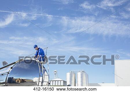 Worker on top of stainless steel milk tanker View Large Photo Image Stock Image - Worker on top of stainless steel milk tanker. Fotosearch
