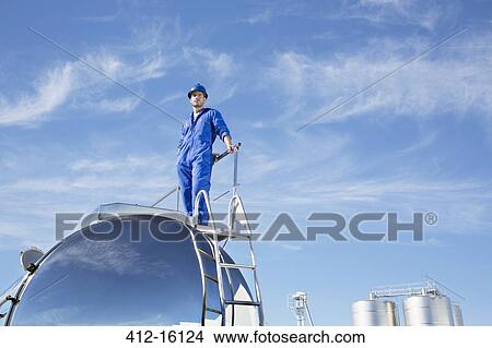 Worker standing on stainless steel milk tanker View Large Photo Image Picture - Worker standing on stainless steel milk tanker. Fotosearch