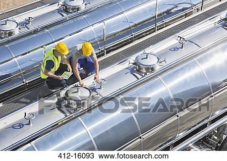 Workers on platform above stainless steel milk tanker View Large Photo Image Stock Image - Workers on platform above stainless steel milk tanker. Fotosearch