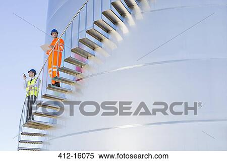 Workers on winding stairs along silage storage tower View Large Photo Image Stock Photography - Workers on winding stairs along silage storage tower. Fotosearch