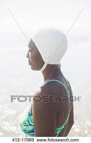 Pensive woman in bathing suit and cap View Large Photo Image Stock Photo - Pensive woman in bathing suit and cap. Fotosearch