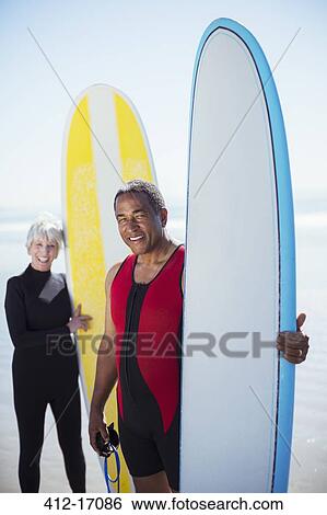 Portrait of senior couple with surfboards View Large Photo Image Stock Photograph - Portrait of senior couple with surfboards. Fotosearch