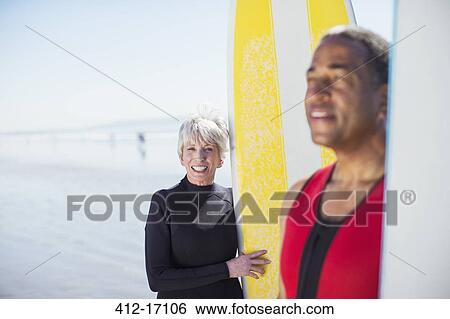 Portrait of senior couple with surfboards on beach View Large Photo Image Stock Photograph - Portrait of senior couple with surfboards on beach. Fotosearch