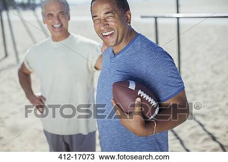 Portrait of senior men with football on beach View Large Photo Image Stock Image - Portrait of senior men with football on beach. Fotosearch