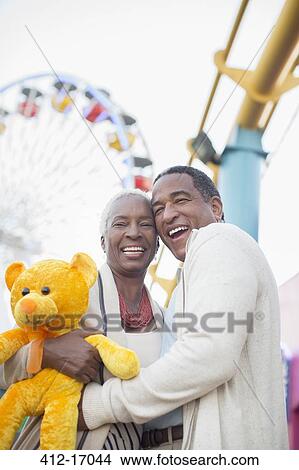 Portrait of smiling senior couple at amusement park View Large Photo Image Picture - Portrait of smiling senior couple at amusement park. Fotosearch