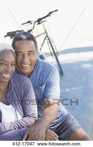 Portrait of smiling senior couple near bicycle View Large Photo Image Stock Photo - Portrait of smiling senior couple near bicycle. Fotosearch