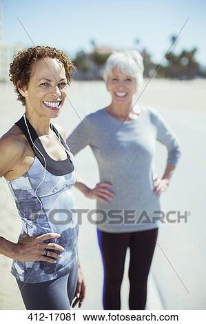 Stock Image - Portrait of smiling women in sportswear outdoors. Fotosearch