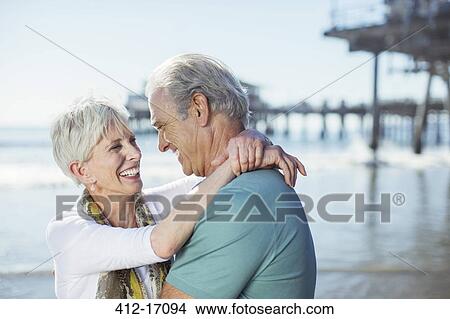 Senior couple hugging on beach View Large Photo Image Picture - Senior couple hugging on beach. Fotosearch