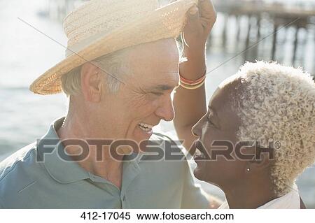 Stock Photography - Senior couple on sunny beach. Fotosearch
