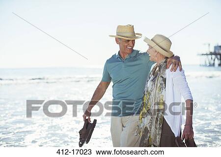 Senior couple walking on beach View Large Photo Image Stock Image - Senior couple walking on beach. Fotosearch