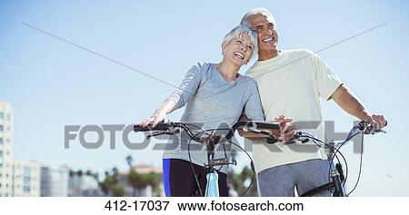 Senior couple with bicycles on beach View Large Photo Image Stock Photo - Senior couple with bicycles on beach. Fotosearch