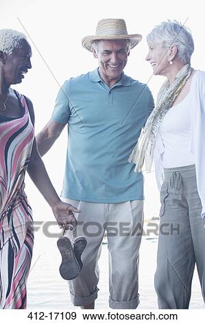 Stock Photo - Senior friends laughing outdoors. Fotosearch