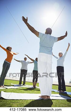 Seniors practicing yoga in sunny park View Large Photo Image Stock Photography - Seniors practicing yoga in sunny park. Fotosearch