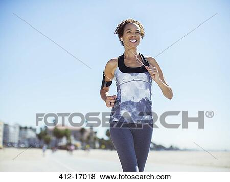 Woman running on beach View Large Photo Image Stock Photo - Woman running on beach. Fotosearch
