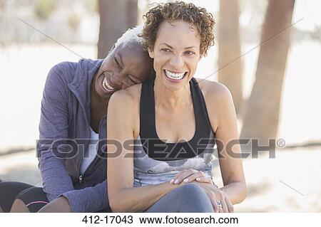 Women laughing outdoors View Large Photo Image Stock Image - Women laughing outdoors. Fotosearch