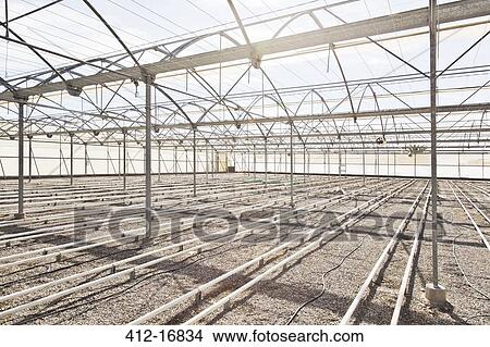 Irrigation pipes in empty greenhouse View Large Photo Image Picture - Irrigation pipes in empty greenhouse. Fotosearch