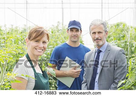 Portrait of confident business owner and workers in greenhouse View Large Photo Image Stock Image - Portrait of confident business owner and workers in greenhouse. Fotosearch
