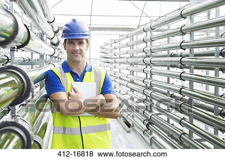 Portrait of confident engineer in greenhouse View Large Photo Image Stock Photo - Portrait of confident engineer in greenhouse. Fotosearch
