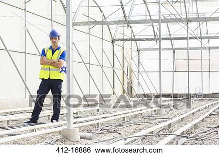 Portrait of confident engineer in greenhouse View Large Photo Image Stock Photograph - Portrait of confident engineer in greenhouse. Fotosearch