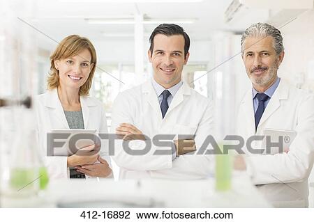 Stock Image - Portrait of confident scientists in laboratory. Fotosearch