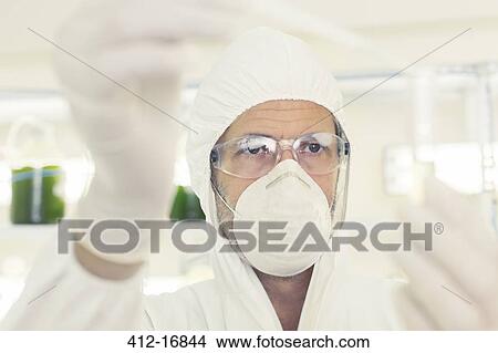 Scientist in clean suit with pipette and test tube View Large Photo Image Picture - Scientist in clean suit with pipette and test tube. Fotosearch