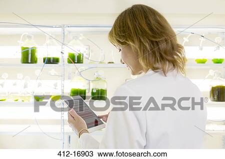 Stock Image - Scientist using digital tablet in laboratory. Fotosearch
