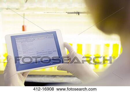 Stock Photo - Scientist using digital tablet in laboratory. Fotosearch