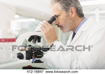 Stock Photo - Scientist using microscope in laboratory. Fotosearch