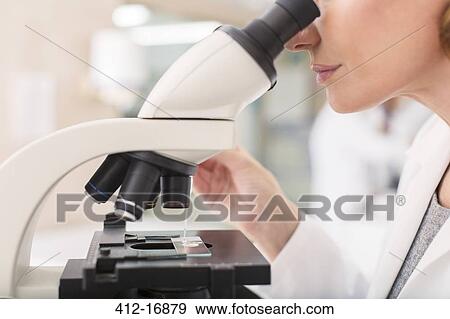 Scientist using microscope in laboratory View Large Photo Image Stock Photo - Scientist using microscope in laboratory. Fotosearch