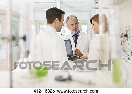Scientists working at laptop in laboratory View Large Photo Image Stock Photography - Scientists working at laptop in laboratory. Fotosearch
