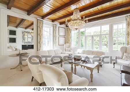 Chandelier hanging in luxury living room View Large Photo Image Stock Image - Chandelier hanging in luxury living room. Fotosearch