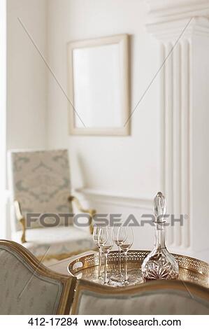Picture - Crystal sherry decanter and cordial glasses in luxury living room. Fotosearch