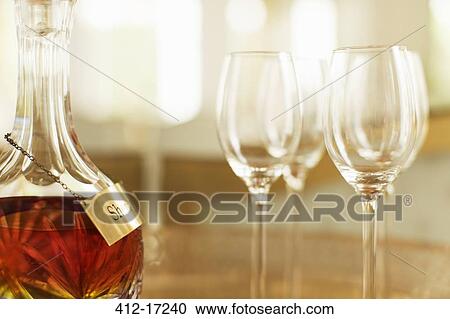 Stock Image - Crystal sherry decanter and cordial glasses. Fotosearch