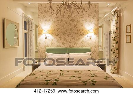 Stock Photo - Luxury bedroom with illuminated sconces. Fotosearch