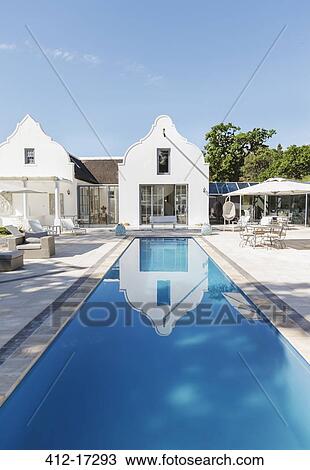 Stock Image - Luxury house and lap pool. Fotosearch